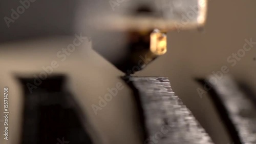 A 3D printer working to create a modern abstract bowl.