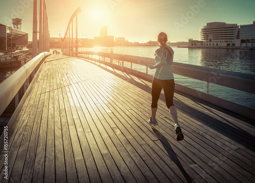 Photography Woman running on the bridge under sunlight.