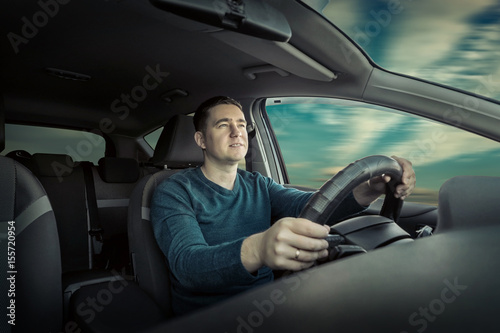 Man is driving a car © Andrii IURLOV