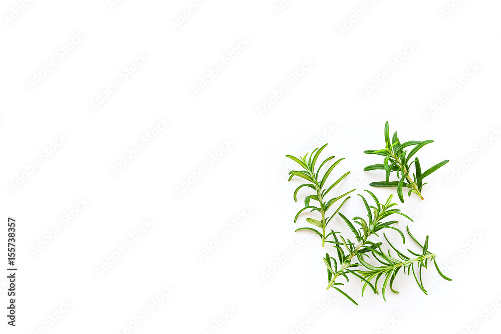 Fototapeta premium Fresh branches with leaves of organic rosemary seen from above isolated on a white background