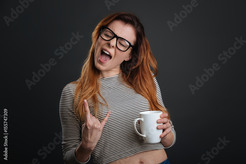 Confident active girl rocking morning coffee