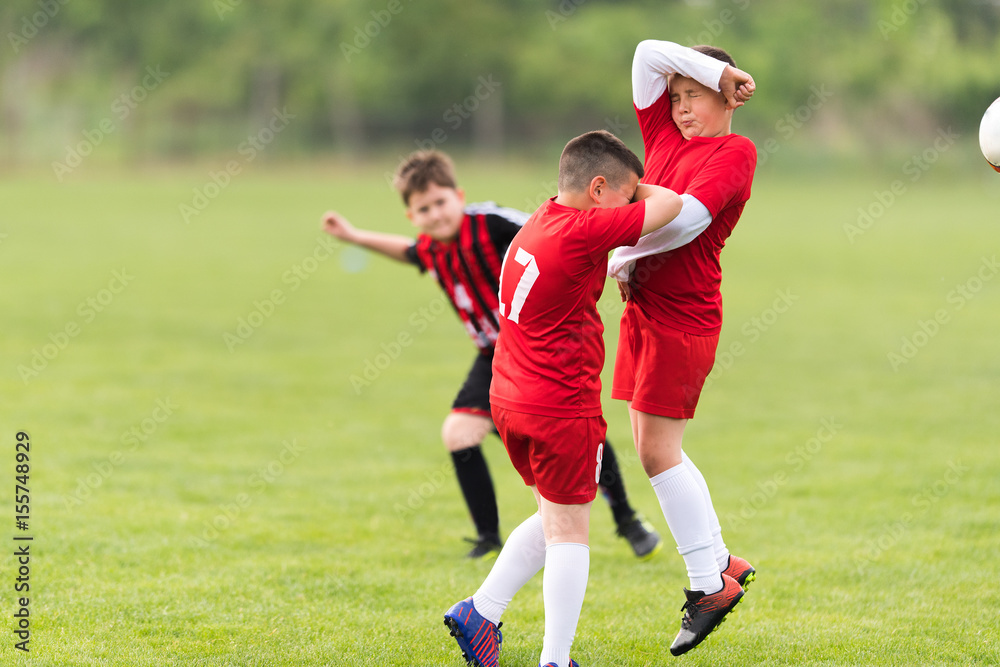 Obraz premium Kids soccer football - children players match on soccer field