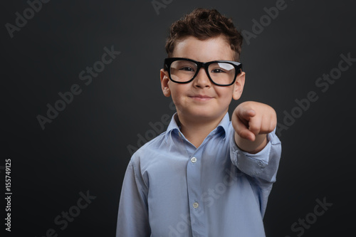Charismatic inspiring kid pointing at you