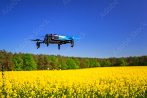 Drone flying over blossom rapeseed field