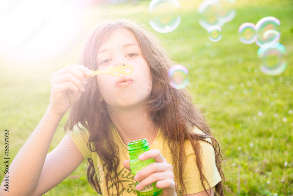 Girl blowing soap bubbles outdoors Girl blowing soap bubbles outdoors