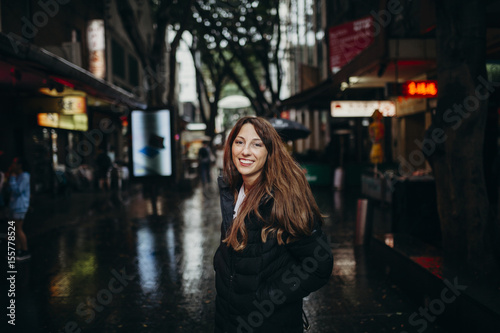 Smiling woman enjoying chinatown neighborhood in Sydney, Australia