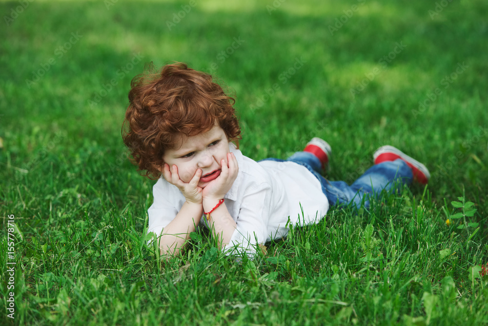 little modern boy on the grass