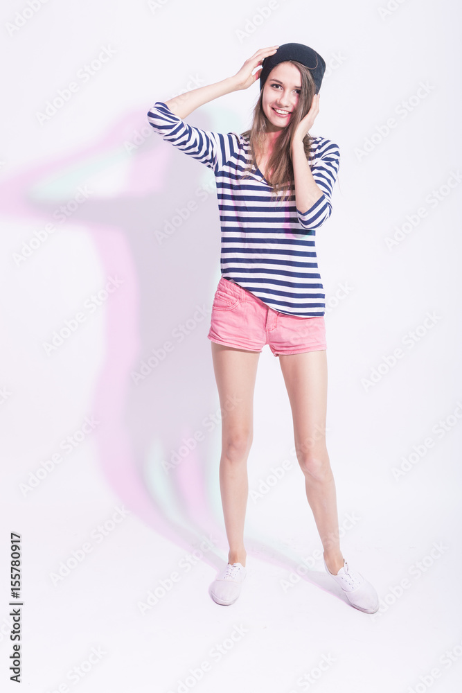 Full Length Portrait of Happy Smiling Caucasian Brunette in Hat and Striped Shirt. Posing Against White Backgroud. Full Length Portrait of Happy Smiling Caucasian Brunette in Hat and Striped Shirt. Posing Against White Backgroud.