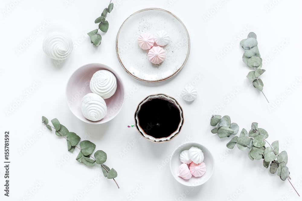 Fototapeta premium sweet lunch with marsh-mallow and spring flowers for woman on white background top view