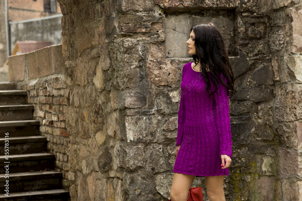 The beauty in a bright knitted dress, walk around the city