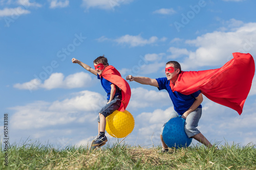 Father and son playing superhero at the day time.