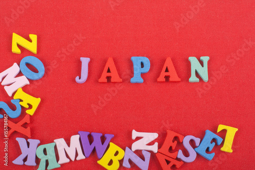 JAPANESE word on red background composed from colorful abc alphabet block wooden letters, copy space for ad text. Learning english concept.