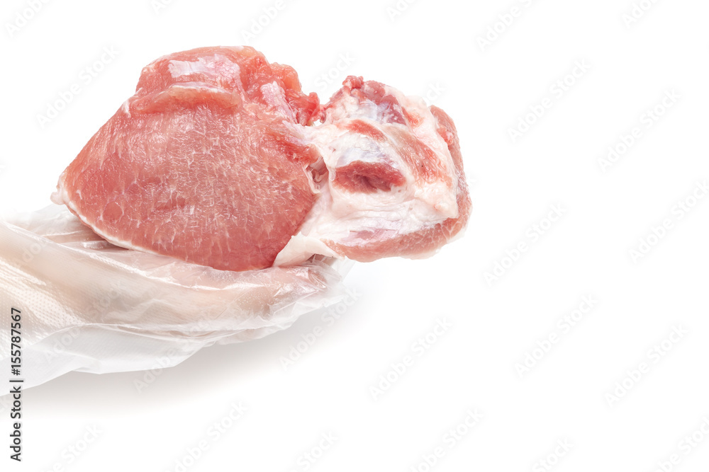 Butcher is holding raw pork meat by hand on white background isolated