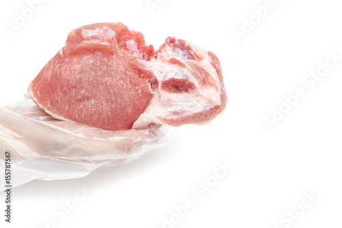 Obraz na płótnie Butcher is holding raw pork meat by hand on white background isolated w salonie
