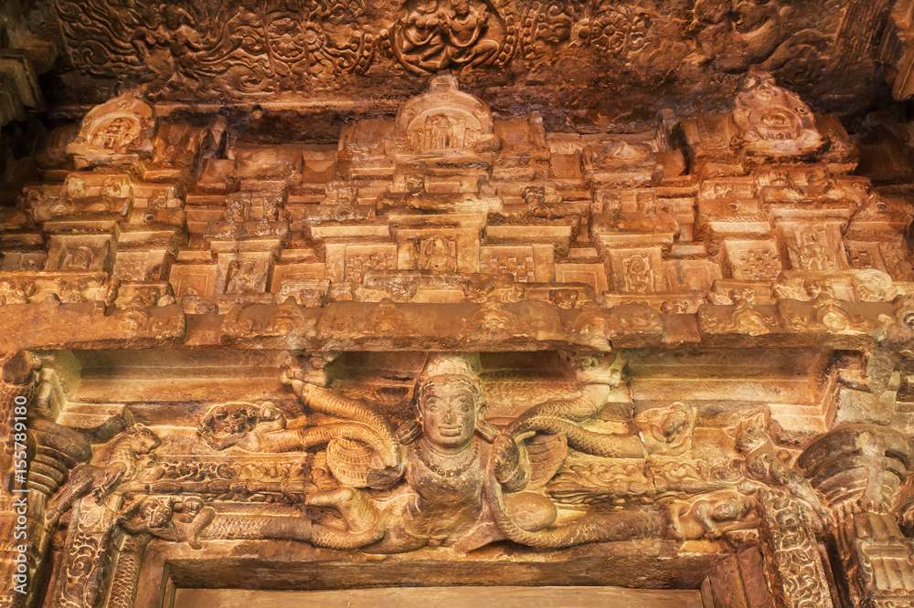 Sculptures of magic heroes over entrance to the 7th century Durga temple, medieval era Hindu temple in Aihole, India. Ancient Indian artwork. Sculptures of magic heroes over entrance to the 7th century Durga temple, medieval era Hindu temple in Aihole, India. Ancient Indian artwork.
