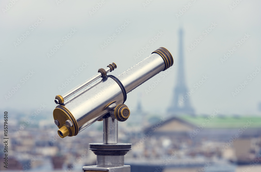 Telescope on the top of roof and panoramic view of Paris with Eiffel tower