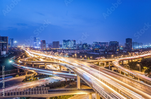 traffic on city road and cityscape at night