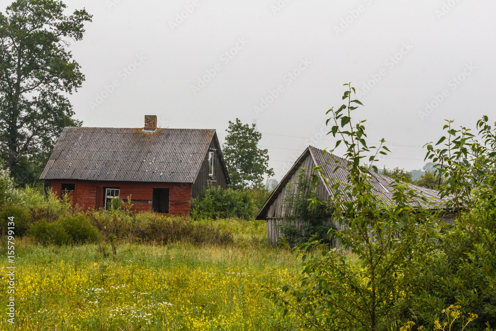 Abandon red house and gray barn in the country. Abandon red house and gray barn in the country.