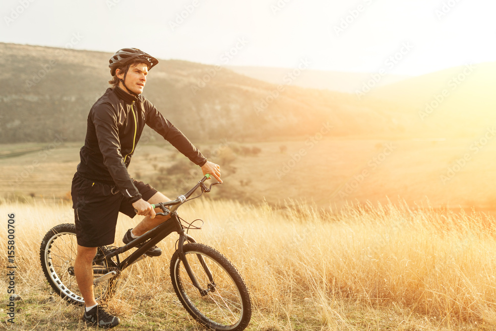 Man on trial bike in the field Man on trial bike in the field