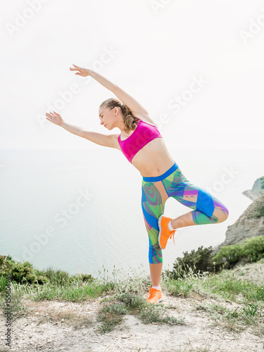 Young fitness girl doing exercise on nature.