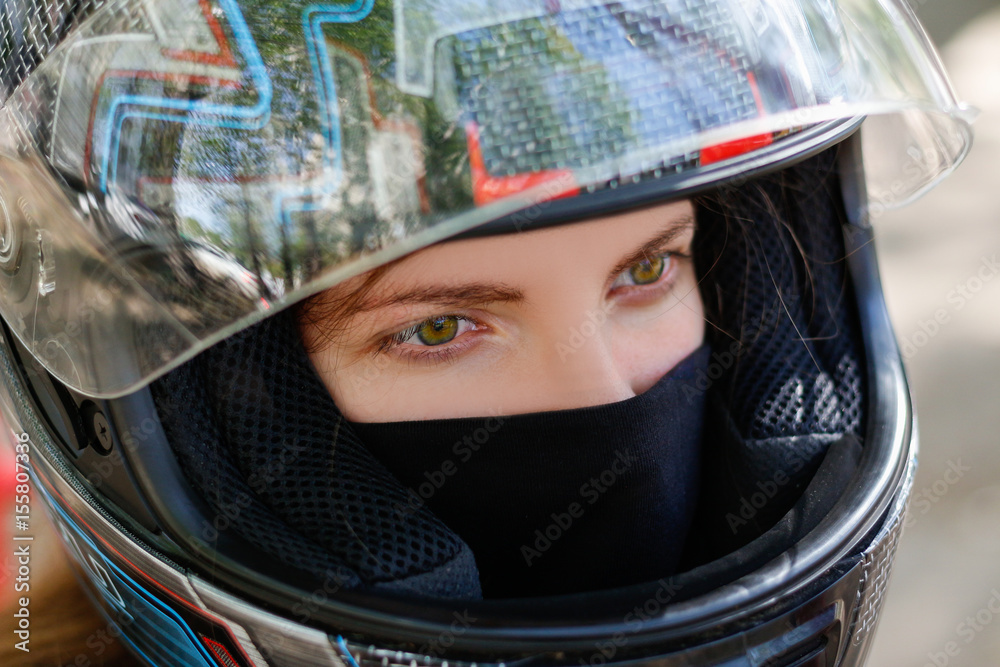 Young girl in a motorcycle helmet Young girl in a motorcycle helmet