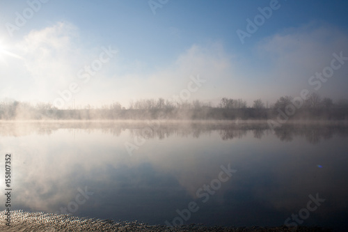 A misty dawn on the river in the early morning in the village