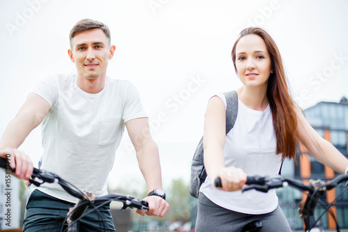 Portrait of happy young couple on bicycles
