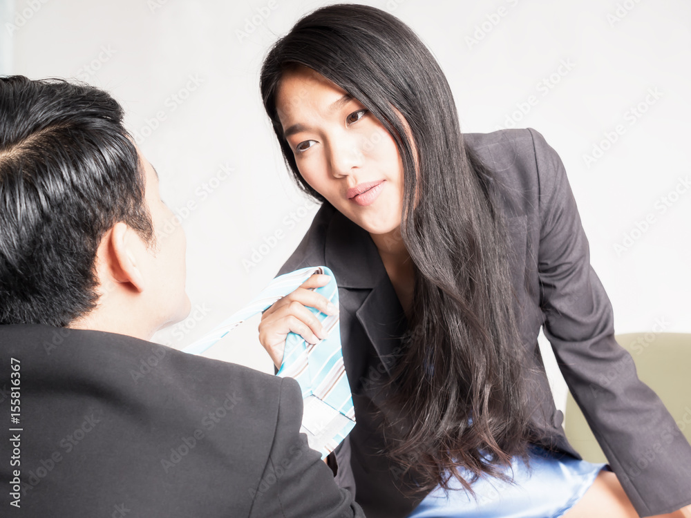 Sexy secretary sitting on the desk and pull a boss' tie Stock Photo | Adobe  Stock