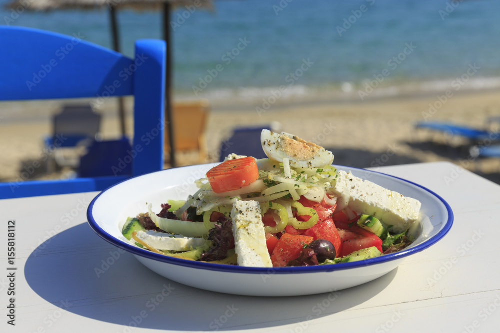Φωτογραφία Greek salad served by the sea, Traditional greek salad on the white wooden table