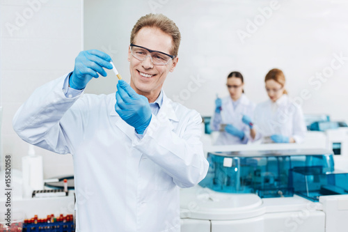 Handsome smiling male scientist looking forward