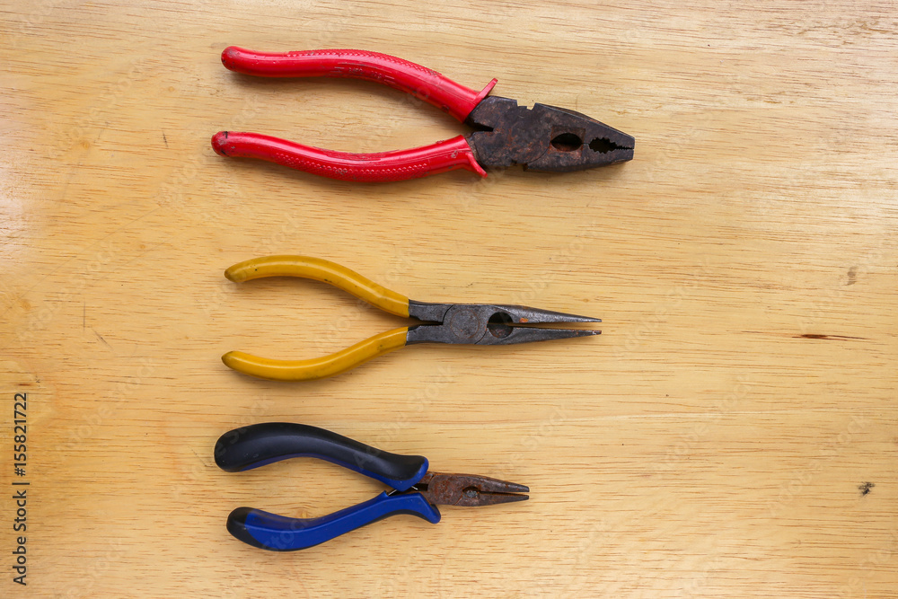 work tools wrench, pliers hand, pliers old,on a wooden table work tools wrench, pliers hand, pliers old,on a wooden table