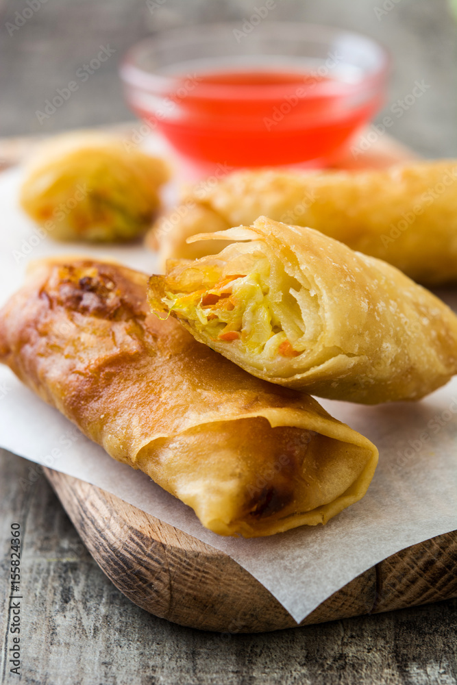 Vegetable spring rolls on wooden table background
Vegetable spring rolls on wooden table background