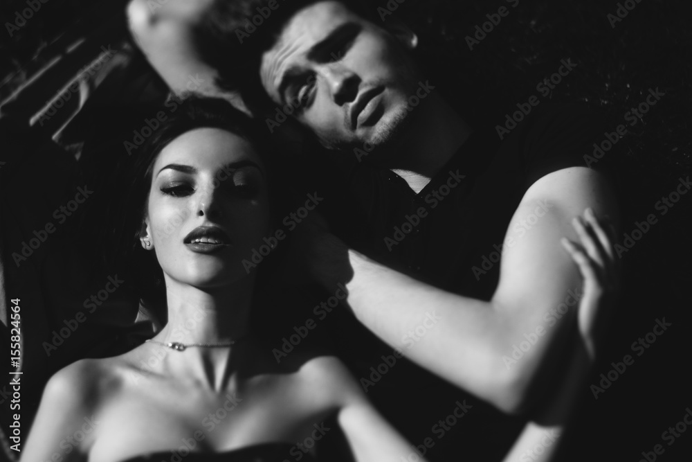 stylish couple lying on the ground and smiling stylish couple lying on the ground and smiling