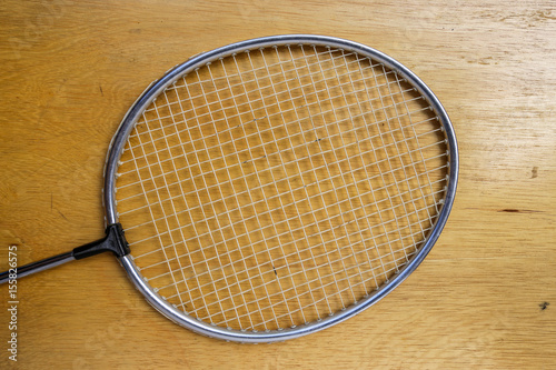 Badminton racket on wood background