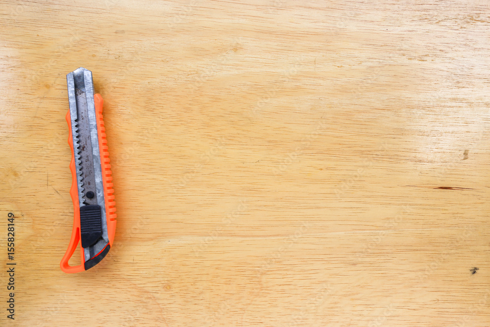 Obraz premium Cutter on wooden floor