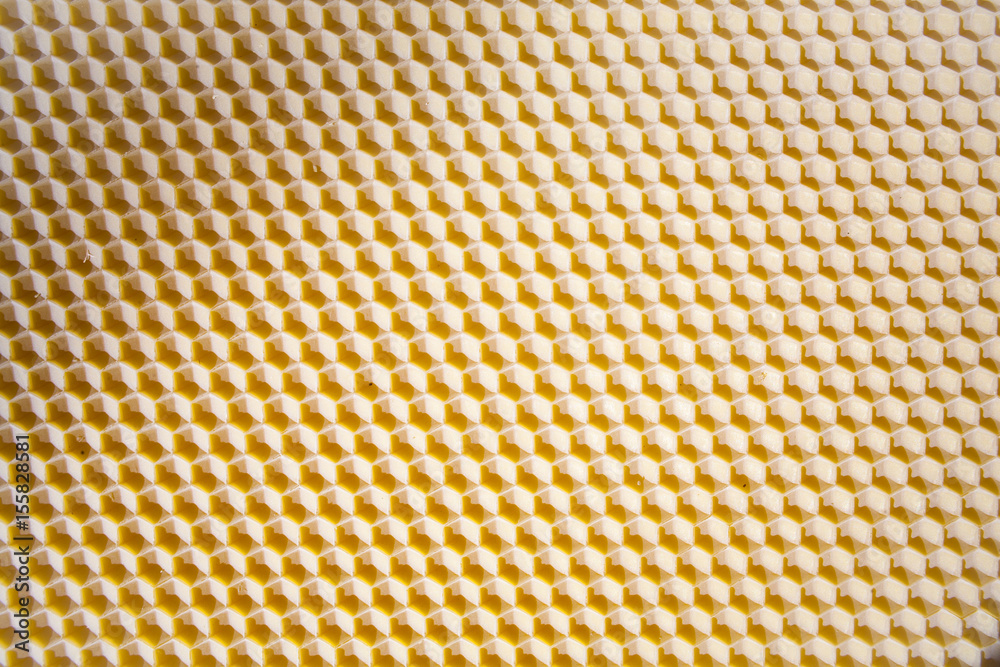 Background texture and pattern of a section of wax honeycomb