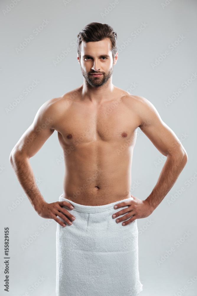 Fototapeta premium Man wearing towel looking camera