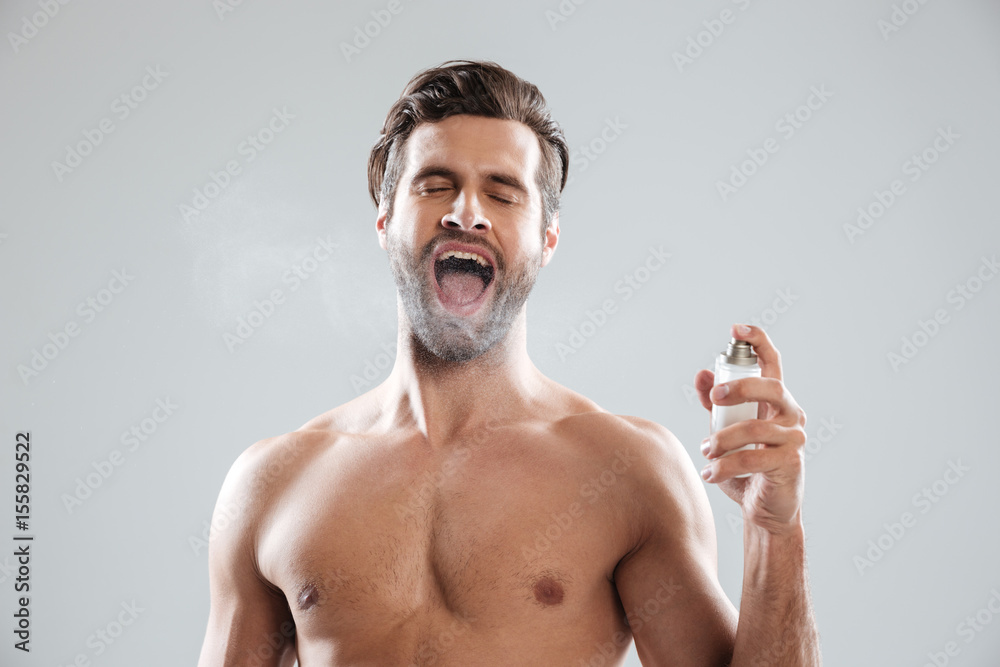 Fototapeta premium Man with opened mouth using toilet water