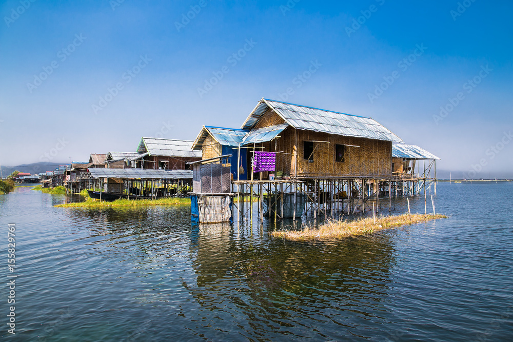 Fototapeta premium Ancient houses and their reflection in the water on the Inle Lake, Myanmar