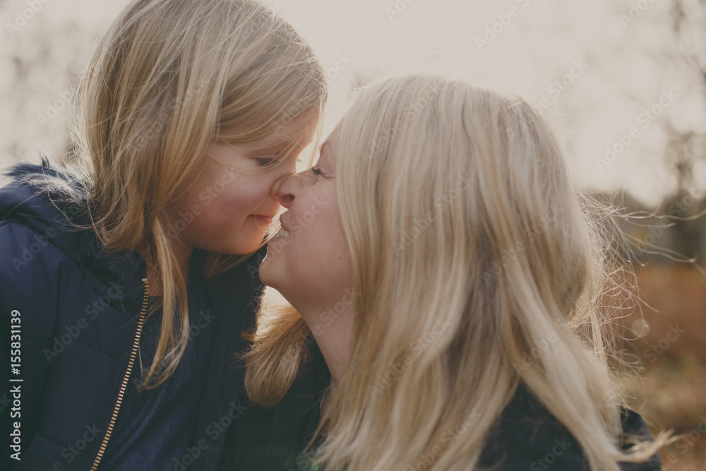 Mother and daughter touching noses