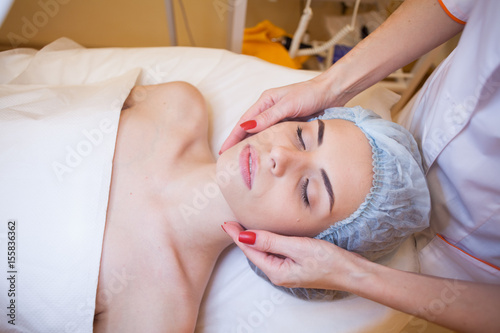 doctor cosmetologist doing facial massage girl spa