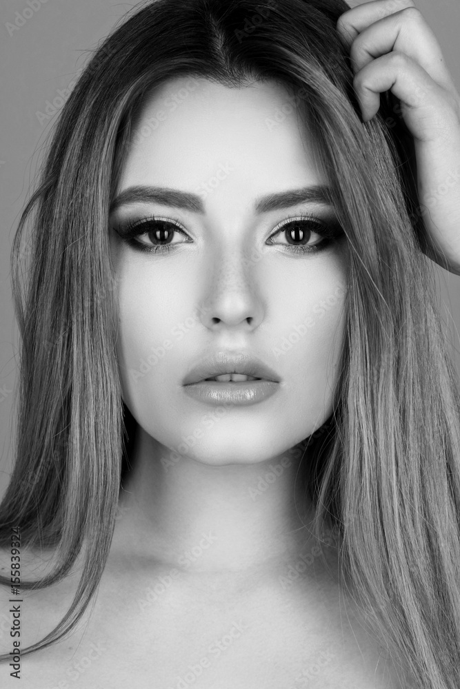 Young beautiful woman in red dress. Closeup beauty fashion portrait. Female model with healthy long straight hair. Red backlight. Young beautiful woman in red dress. Closeup beauty fashion portrait. Female model with healthy long straight hair. Red backlight.