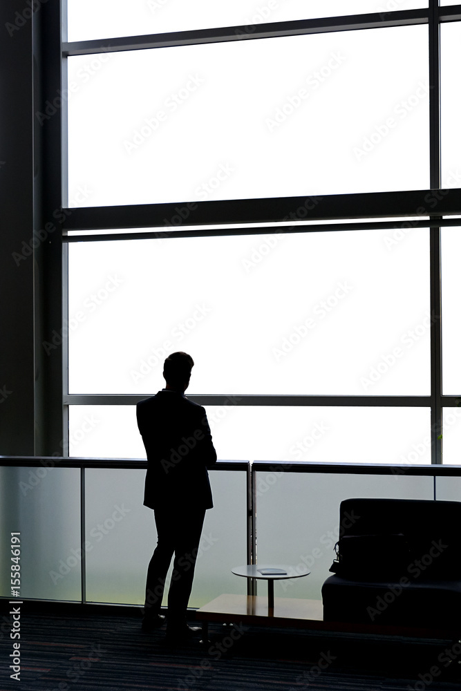 Businessman looking true windows Businessman looking true windows