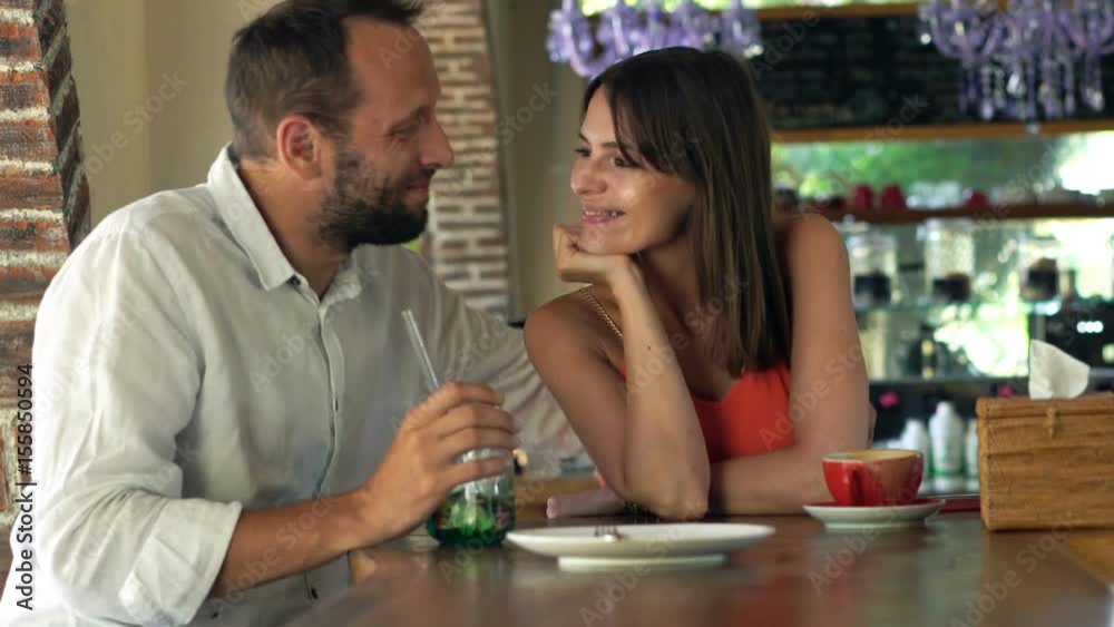 Portrait of happy couple sitting by table in cafe
Portrait of happy couple sitting by table in cafe