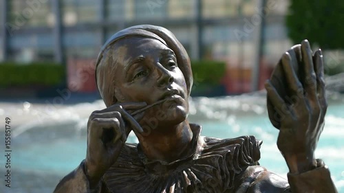 A woman bronze statue with a mirror in the hand in a square in Bratislava