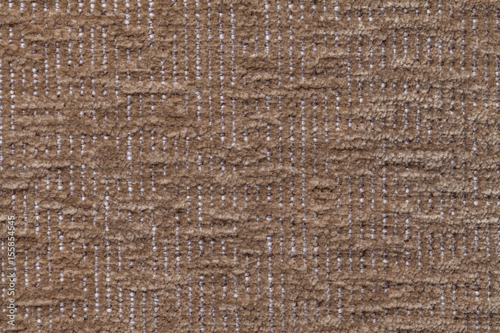 Dark brown fluffy background of soft, fleecy cloth. Texture of plush furry textile, closeup.