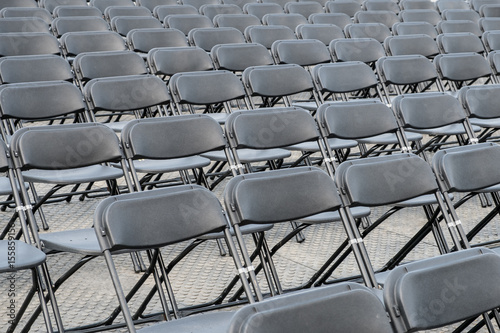 many empty black folding chair rows