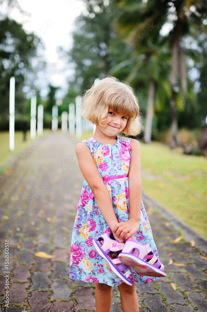 Beautiful little girl is walking in the park Beautiful little girl is walking in the park