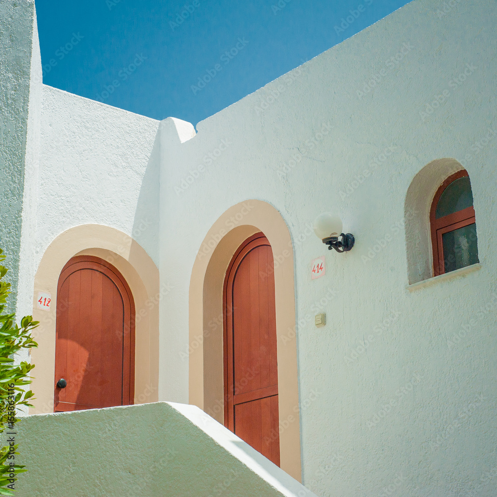 Greek architecture - white buildings, sea and blue windows, tree and flower