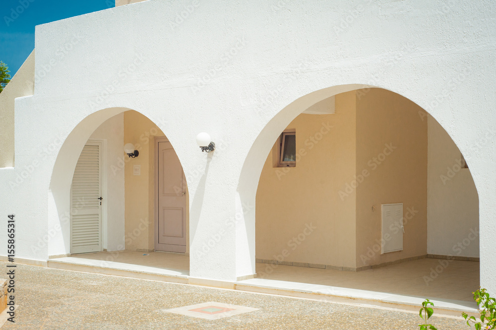 Greek architecture - white buildings, sea and blue windows, tree and flower